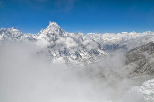 Panoramic view of Kangchenjunga mountains hidden by passing clouds