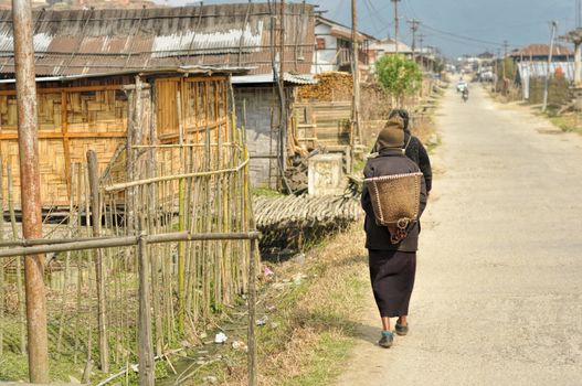 People walking along the street in a poor quarter in Arunachal Pradesh, India