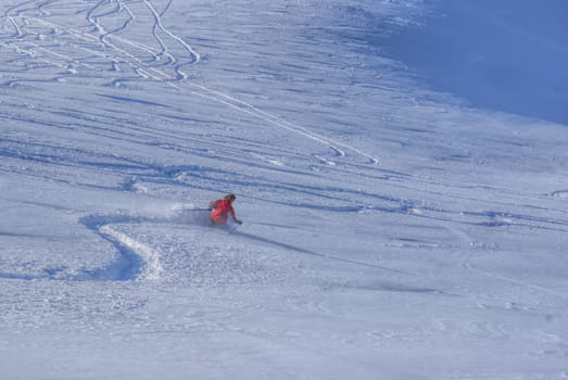Picturesque view of a skier skiing down a snowy slope