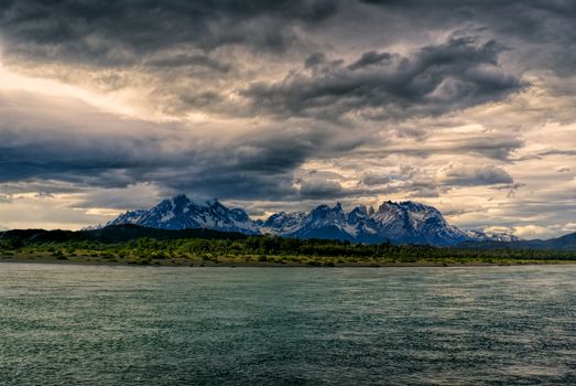 Panoramic view of a peaceful lake surface under grey sky in Torres del Paine National Park