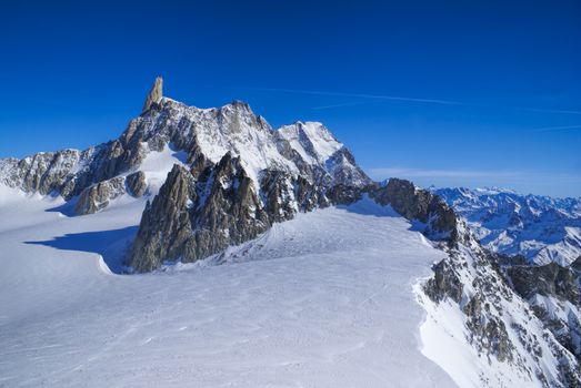 Breathtaking view of snowy mountains from the top in Valle Blanche