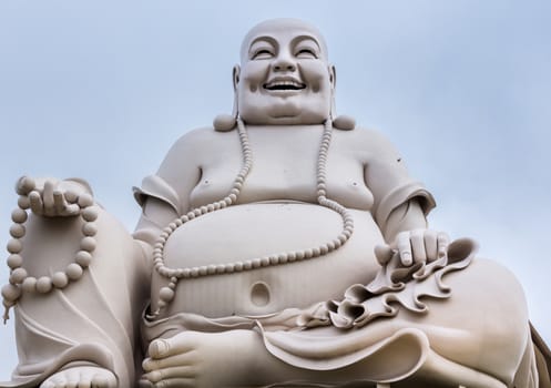 At the Vinh Tranh Pagoda in My Tho, the Mekong Delta, stands this huge statue of the smiling Buddha. Here, the person is isolated and fills the entire picture.