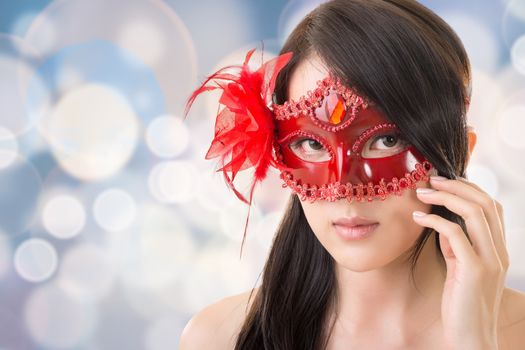 Portrait of Asian young beautiful woman in a carnival mask, closeup portrait.