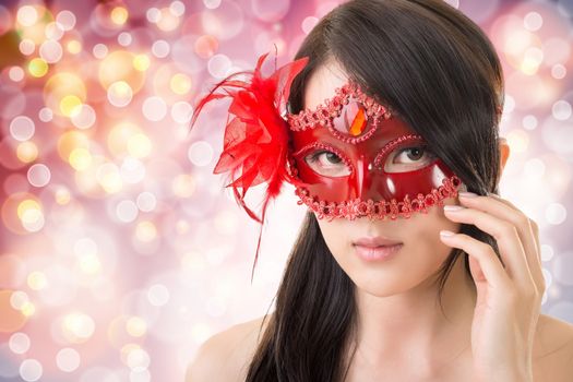 Portrait of Asian young beautiful woman in a carnival mask, closeup portrait.