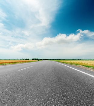 black asphalt road and clouds in dramatic sky