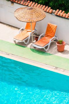 Sun loungers and parasols near the pool