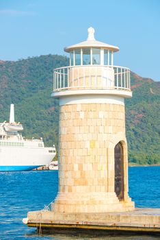 beautiful lighthouse on the background of mountains in the resort