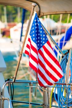 USA flag close-up set on a yacht in the port