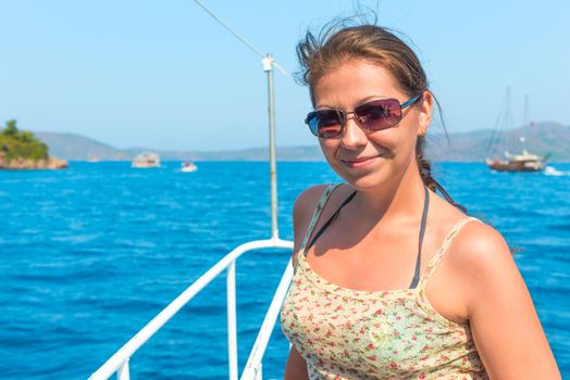 young beautiful brunette on a yacht deck