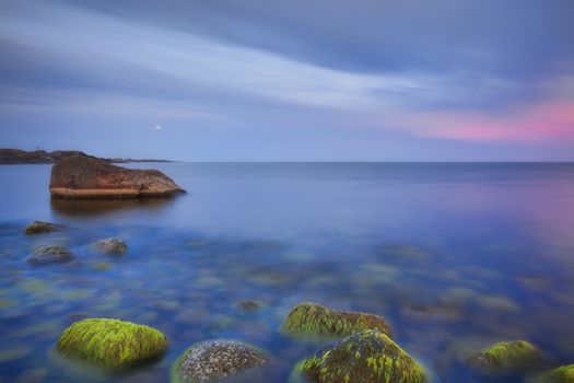 Sunset over the rolling stones of the Norwegian coast, Moelen