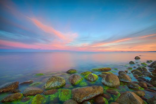 Sunset over the rolling stones of the Norwegian coast, Moelen