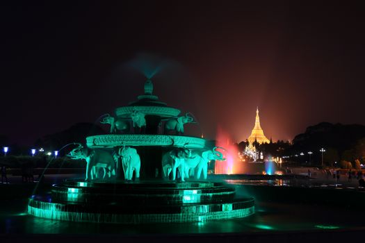 fountain with colorful illuminations at night near the Shwedagon Pagoda