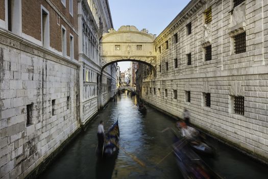 Gondolas passing under Bridge of Sighs, Ponte dei Sospiri. A legend says that lovers will be granted eternal love if they kiss on a gondola at sunset under the Bridge. Venice,Veneto, Italy, Europe. 