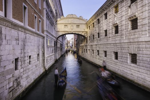 Gondolas passing under Bridge of Sighs, Ponte dei Sospiri. A legend says that lovers will be granted eternal love if they kiss on a gondola at sunset under the Bridge. Venice,Veneto, Italy, Europe. 
