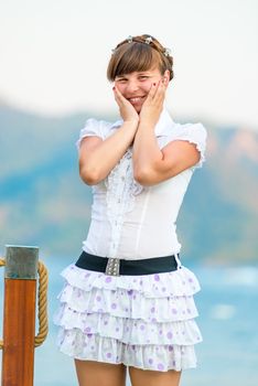 Portrait of a embarrassed girl in white dress