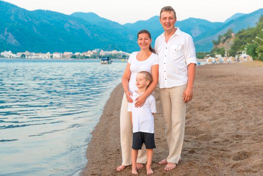 family in bright clothing on a vacation by the sea