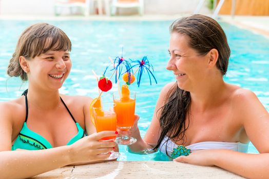 Girl relaxing with cocktails in the pool