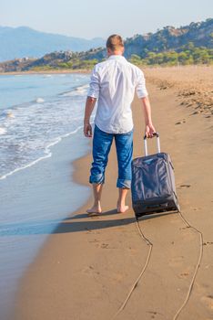 lost tourist with a suitcase on a desert island