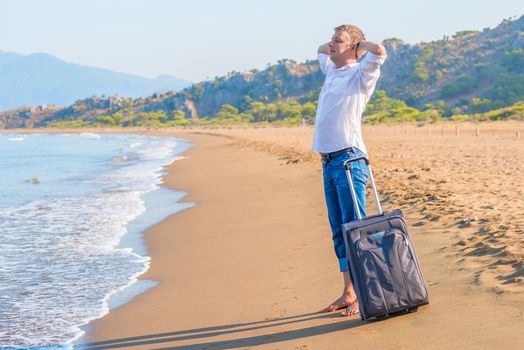 businessman rest on the island with a suitcase