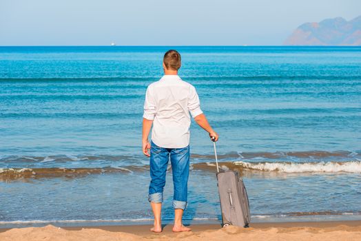 lost on a desert island man looks at the leaving ships