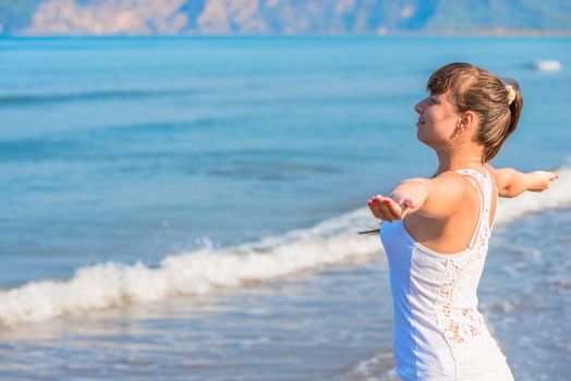 happy beautiful brunette woman looking at the sea