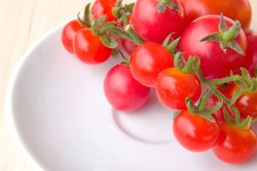 Photo shows a detail of the colourful tomatoes on a white plate.