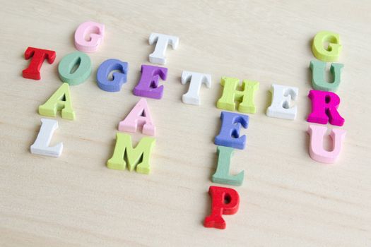 Photo shows a detail of the crossword puzzle funny sign with symbols on a table.