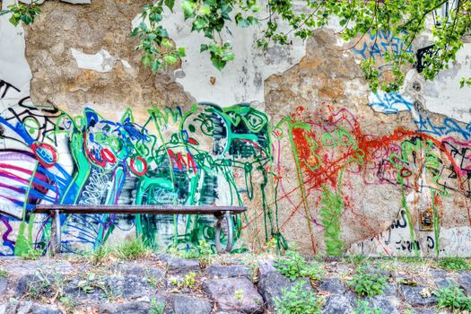 Photo shows the graffiti city wall with seat.