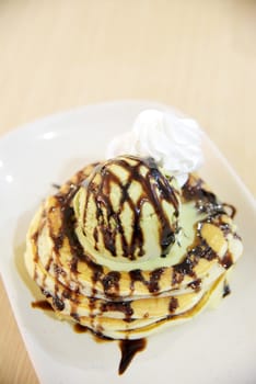 Pancake with green tea ice cream and chocolate sauce