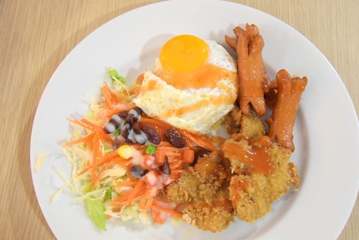 Thai style of fried rice with eeg and chicken deep fried