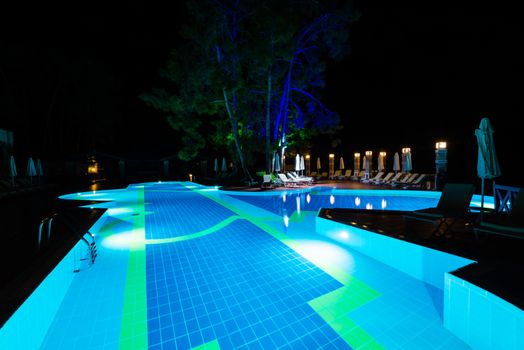 Luxurious tropical resort with gorgeous swimming pool at night