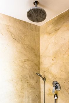 contemporary bathroom with marble and head shower while running water