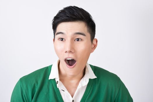 Funny facial expression, closeup Asian young man.