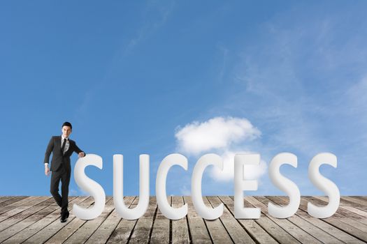 Concept of success with man and the 3d text under copyspace of sky.