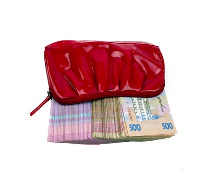 Ukrainian paper notes in red women's purse on a white background