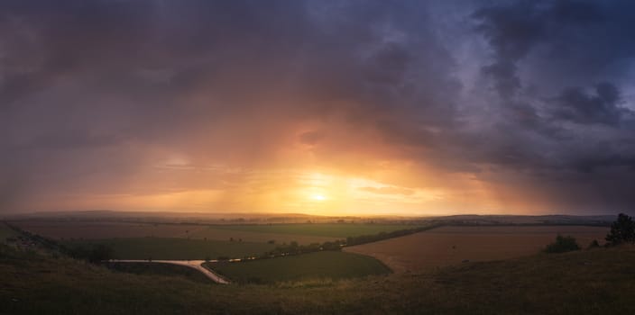 Colorful Sunset and Dramatic Sky over Illuminated Landscape