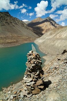 Mountain lake  with the Buddhist stupa at the forefront