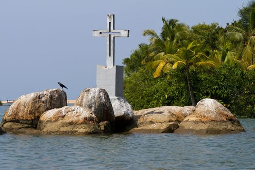 The Christian cross on a small island in backwaters (Kerala, India)