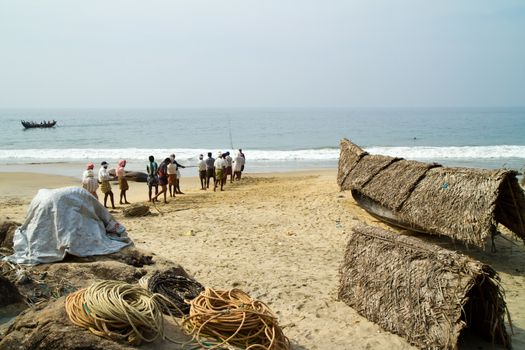 fishermen pulling a fishing net from the Arabian Sea (Kerala, India)