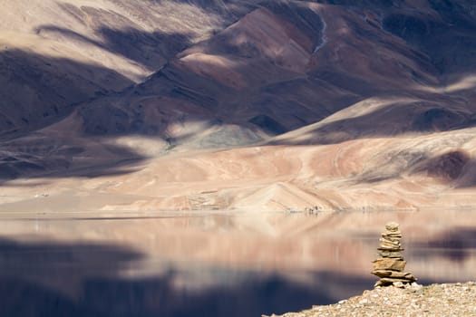 Tsomoriri mountain lake with fantastic mountains background and reflections in the lake with buddhist stupa at the forefront (north India)