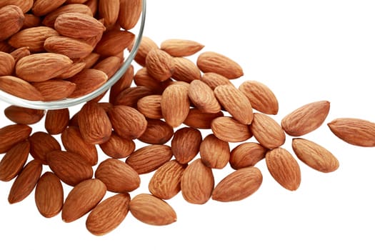 Glass bowl with almonds nuts isolated on white background.