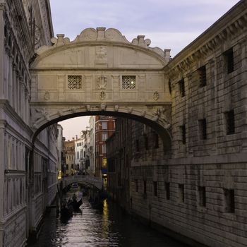 Gondolas passing under Bridge of Sighs, Ponte dei Sospiri. A legend says that lovers will be granted eternal love if they kiss on a gondola at sunset under the Bridge. Venice,Veneto, Italy, Europe. 