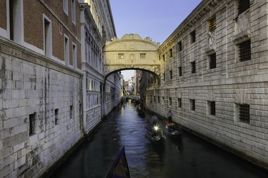 Gondolas passing under Bridge of Sighs, Ponte dei Sospiri. A legend says that lovers will be granted eternal love if they kiss on a gondola at sunset under the Bridge. Venice,Veneto, Italy, Europe. 
