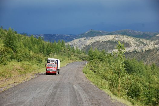 Truck at mountain gravel road Kolyma highway at Russian outback, Yakutia