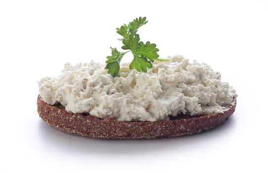 Sandwich with rye bread, cottage cheese and parsley on the white plate