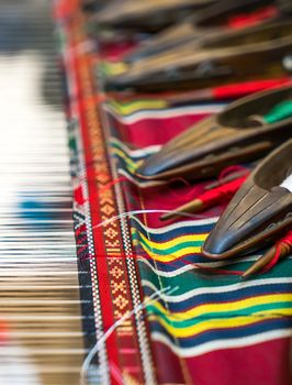 Weaving shuttles and colorful textile with pattern