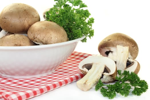 a bowl of brown mushrooms and parsley