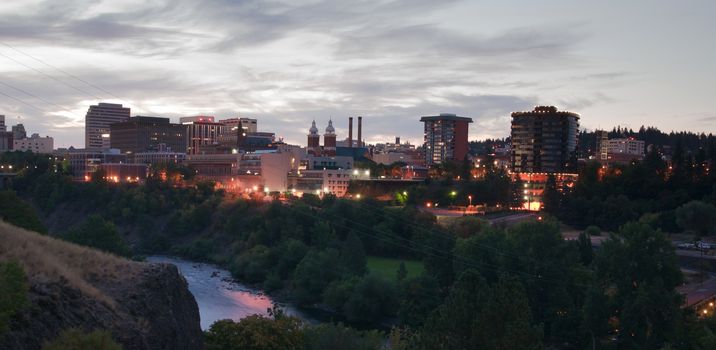 The buildings still have the lights on as the sun comes up in Spokane Washington