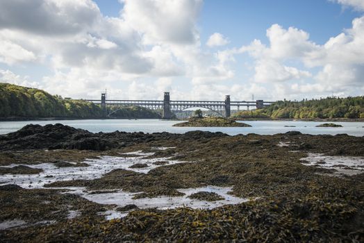 A view of the historic Menai suspension bridge spanning the Menai Straits, Gwynnedd, Wales, UK.