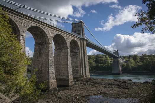 A view of the historic Menai suspension bridge spanning the Menai Straits, Gwynnedd, Wales, UK.